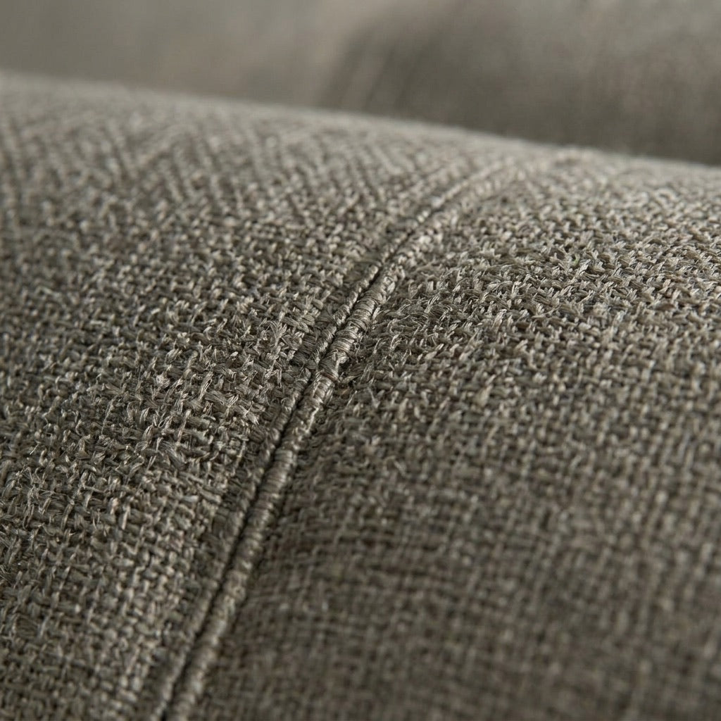 Close-up of upholstery fabric weave — the fibers where odor actually bonds